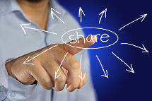 male businessman pointing finger to click share icon on virtual display